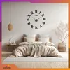A bedroom scene with a large wall clock above a bed. Náhled obrázku produktu