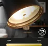 Close-up of a black LED table lamp with a golden interior, showing its dimming feature with a slider and percentage indicators. Náhľad obrázku produktu