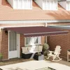 An awning is extended over a patio area with outdoor furniture. Anteprima dell’immagine prodotto