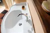 A close-up view of a white sink with a chrome faucet and a bar of soap on the ledge. Anteprima dell’immagine prodotto