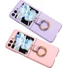 Two flip phone cases, one purple and one pink, are displayed against a white background. Produktbild-Vorschau