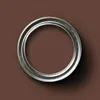 A top-down view of a metal ring on a brown background. Produktbild-Vorschau