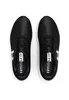 A top-down view of a pair of black Under Armour sneakers with white soles. Produktbild-Vorschau