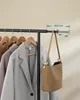 A garment rack with several coats and a handbag on display. Náhled obrázku produktu
