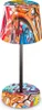 A table lamp with a graffiti-like design on its shade and base. Anteprima dell’immagine prodotto