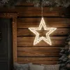 A lighted star decoration hangs on a wooden wall, with a Christmas tree and pillows visible. Podgląd zdjęcia produktu