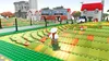 A LEGO-themed video game scene with a character in the foreground and buildings in the background. Produktbild-Vorschau