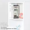 A close-up view of a white shelf unit with books and decorative items. Produktbild-Vorschau