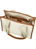 An open view of a white tote bag with brown trim and handles. Anteprima dell’immagine prodotto