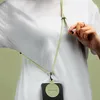 A person wearing a white t-shirt is holding a phone with a lanyard. Anteprima dell’immagine prodotto
