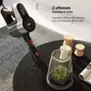 A cordless vacuum cleaner is shown on a table next to some decorative items and a magazine. Voir les images du produit
