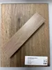 A sample of vinyl flooring with a label. Produktbild-Vorschau