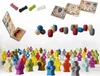 A collage of game components including meeples, barrels, and cards. Náhled obrázku produktu