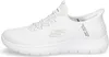 A side view of a white Skechers slip-on sneaker. Produktbild-Vorschau