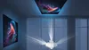 A projector projecting images onto a wall and ceiling in a dark room. Produktbild-Vorschau