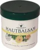 A white jar with a green lid containing skin balm, with marigold flowers depicted on the label. Náhľad obrázku produktu