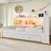 A white bed with storage drawers and a lighted headboard in a bedroom. Voir les images du produit