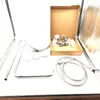 A collection of chrome-plated shower components laid out on a white surface, including a shower head, hose, and mounting hardware in a box. Produktbild-Vorschau
