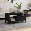 A black coffee table is placed in a living room setting with a sofa and a rug. Produktbild-Vorschau