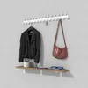 A wall-mounted coat rack with a shelf displaying various items. Produktbild-Vorschau
