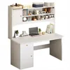 A white computer desk with shelves and a cabinet, featuring a laptop and decorative items. Náhled obrázku produktu