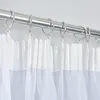 A close-up view of white sheer curtains hanging from a metal curtain rod. Produktbild-Vorschau