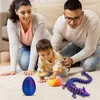 A family playing with toys on the floor. Produktbild-Vorschau