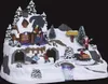 A festive Christmas village scene with Santa, children building a snowman, and a house. Náhľad obrázku produktu