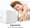 A child sleeping next to a mini-refrigerator. Produktbild-Vorschau