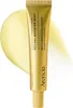 A gold tube of face and eye cream moisturizer with a yellow swatch of cream behind it. Voir les images du produit