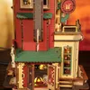 A close-up view of a detailed wooden model of a gift factory building, with festive decorations. Podgląd zdjęcia produktu