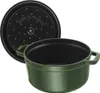 A green Staub cast iron cocotte with its black lid, shown with the lid slightly ajar. Voir les images du produit