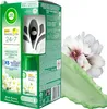 The image shows the packaging of an Air Wick Freshmatic automatic spray air freshener, along with a depiction of white flowers and a green liquid splash. Anteprima dell’immagine prodotto