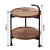 A two-tiered round side table with wooden tops and a black metal frame, with dimensions indicated. Produktbild-Vorschau