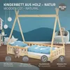 A wooden children's bed with a teepee-like frame, set up in a room with a blue, wavy wall mural. Decorative elements like hanging lights, a teddy bear, and a chair are visible in the background. Produktbild-Vorschau