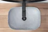 A top-down view of a grey oval sink with a black faucet, placed on a wooden surface. Anteprima dell’immagine prodotto