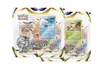 Two blister packs of Pokemon trading cards, each containing booster packs, a Pokemon card, and a coin. Produktbild-Vorschau