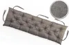 A long, tufted bench cushion in a gray fabric, shown diagonally on a white background. A circular inset shows a close-up of the fabric texture. Produktbild-Vorschau