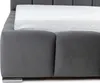 A close-up view of a gray upholstered bed frame with a white mattress. Náhled obrázku produktu