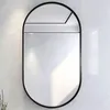 An oval mirror with a black frame is mounted on a textured white wall. Náhled obrázku produktu