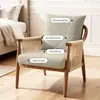 A chair with labels indicating different support areas, placed in a room setting with a bed in the background. Podgląd zdjęcia produktu