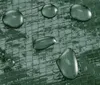 Water droplets on a textured green surface. Produktbild-Vorschau