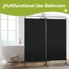 A bathroom with a bathtub and a black room divider. Anteprima dell’immagine prodotto