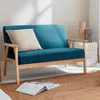A teal loveseat with a beige cushion and wooden legs sits on a jute rug in a well-lit room. Anteprima dell’immagine prodotto
