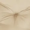 A close-up view of a tufted beige cushion, showing the texture and stitching. Produktbild-Vorschau