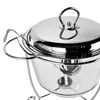 A close-up shot of a stainless steel and glass casserole dish with a lid, resting on a metal stand. Produktbild-Vorschau