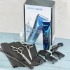 A set of barber tools including a trimmer, scissors, comb, and charging cable, displayed with its packaging. Produktbild-Vorschau