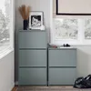 A hallway or entryway with two gray shoe cabinets, a window with a Roman shade, and a black duffel bag. Náhled obrázku produktu
