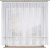 A white lace curtain hanging on a window. Náhled obrázku produktu