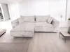 A sectional sofa is shown in a bright, modern living room setting. Náhľad obrázku produktu